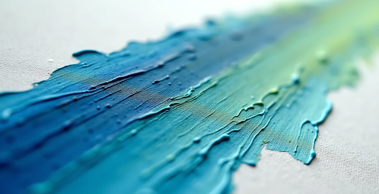 Extreme close-up of paint stroke showing viscosity gradient from thick to thin